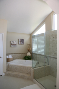 A beautifully remodeled bathroom with a walk-in shower and luxury bathtub