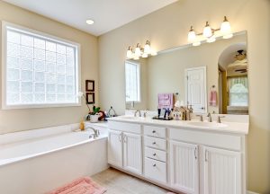 A beautiful bathroom with a soaking tub and white vanity.