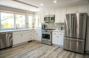 A beautifully remodeled kitchen with white cabinets.