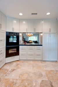 A large open kitchen with white cabinets